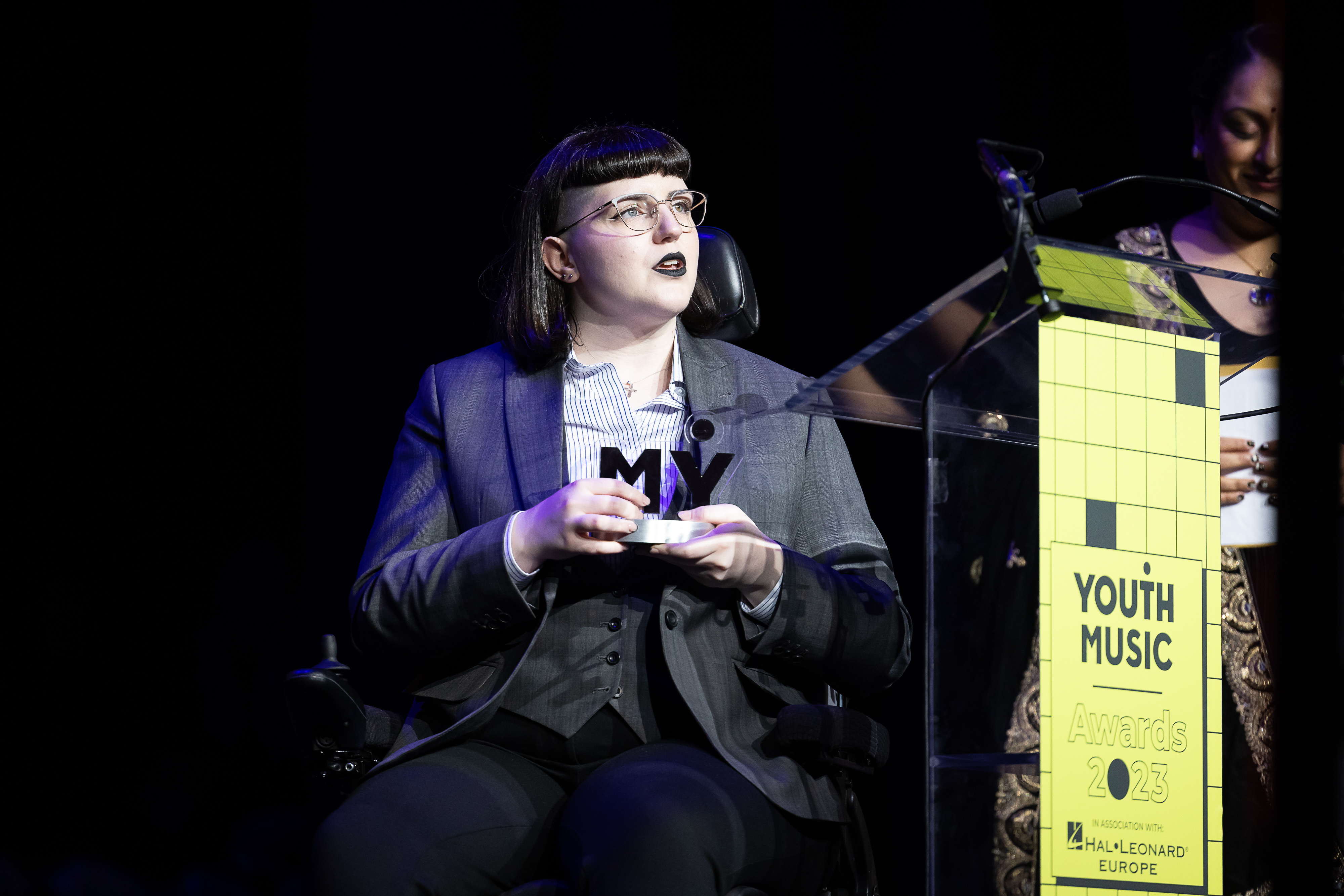 elizabeth birch accepts an award on stage